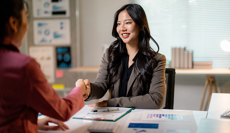 businesswomen shaking hands after reaching an agre