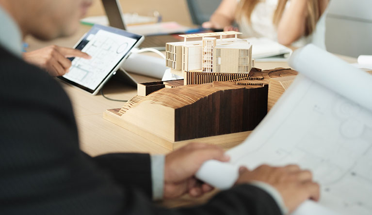 miniature building at business meeting with archit